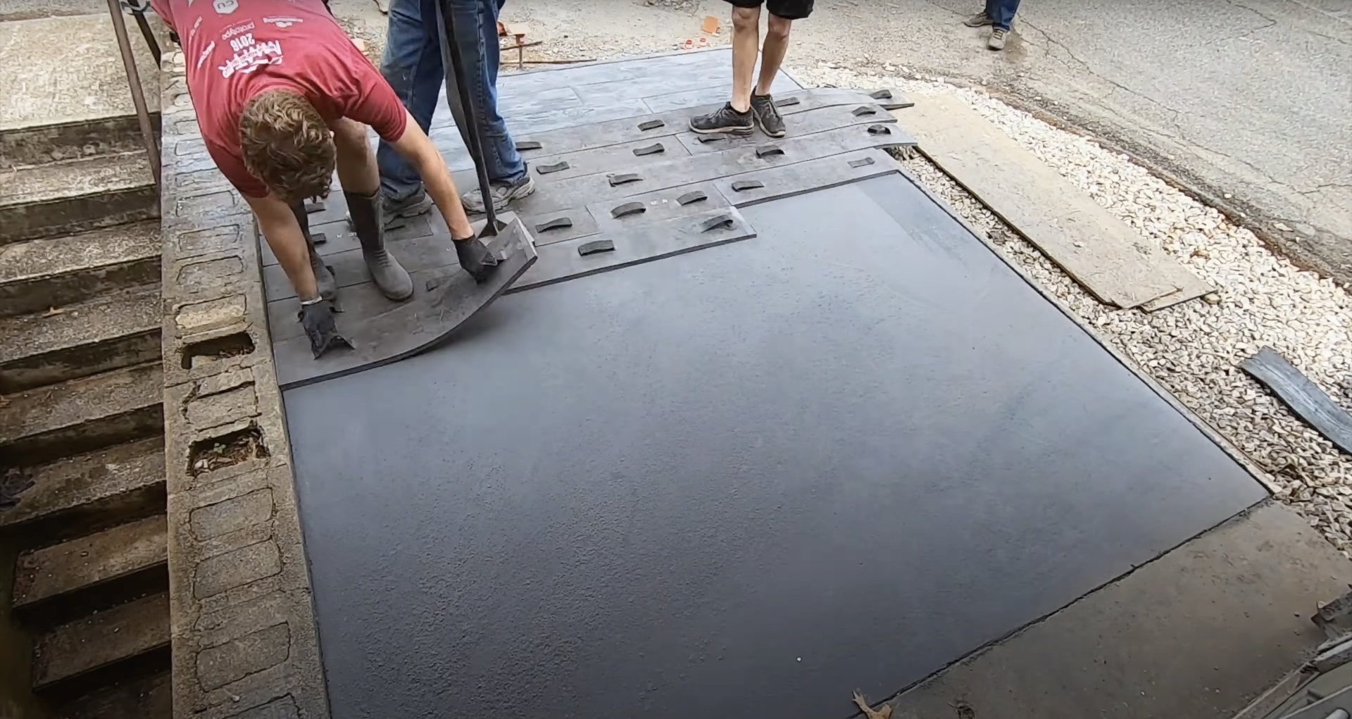 Professional concrete floor installation with specialized tools and equipment