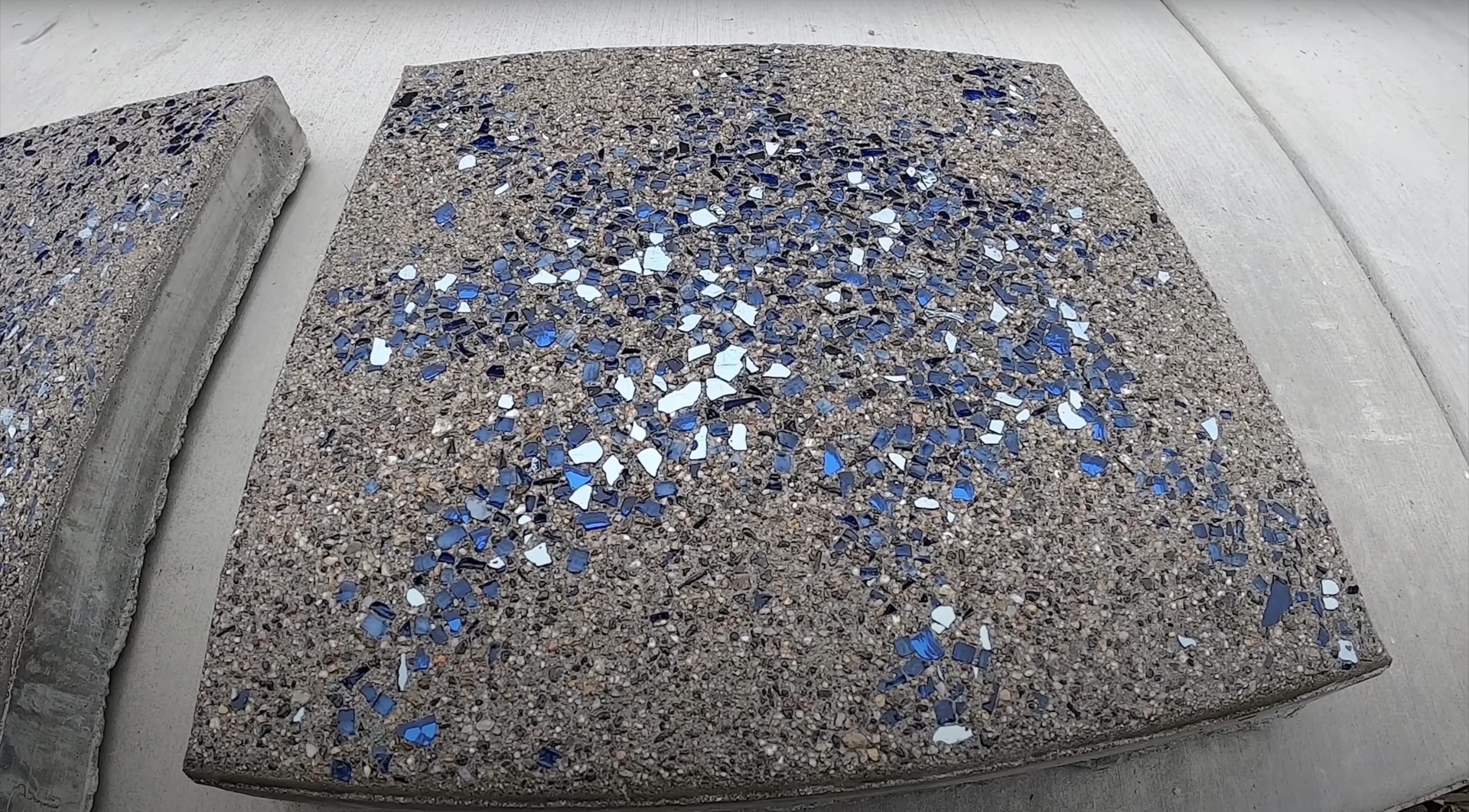 Decorative concrete with blue glass aggregate showing artistic concrete work